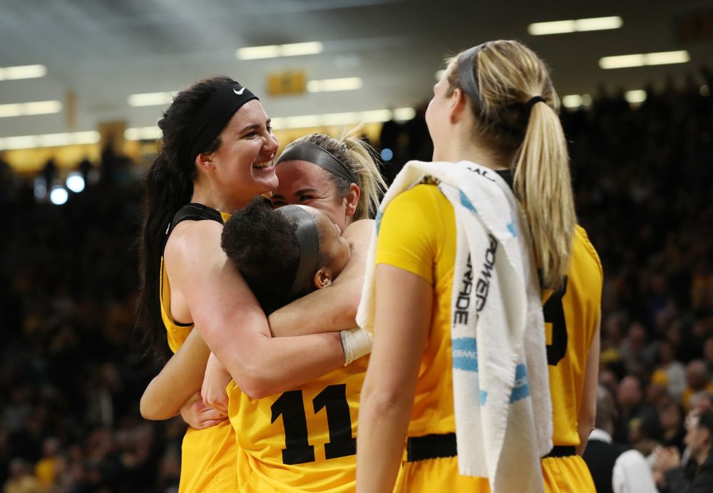 Iowa Hawkeyes forward Megan Gustafson (10) hugs guard Tania Davis (11) and forward Hannah Stewart (21) after they were taken out of the game against the Northwestern Wildcats Sunday, March 3, 2019 at Carver-Hawkeye Arena. (Brian Ray/hawkeyesports.com)
