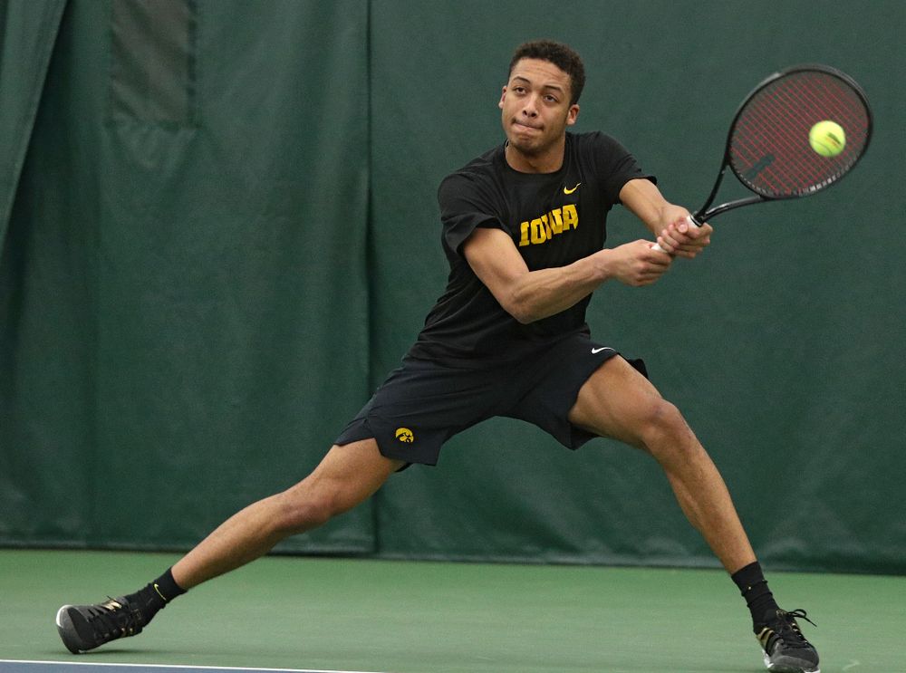 Iowa’s Oliver Okonkwo returns a shot during his singles match at the Hawkeye Tennis and Recreation Complex in Iowa City on Friday, March 6, 2020. (Stephen Mally/hawkeyesports.com)