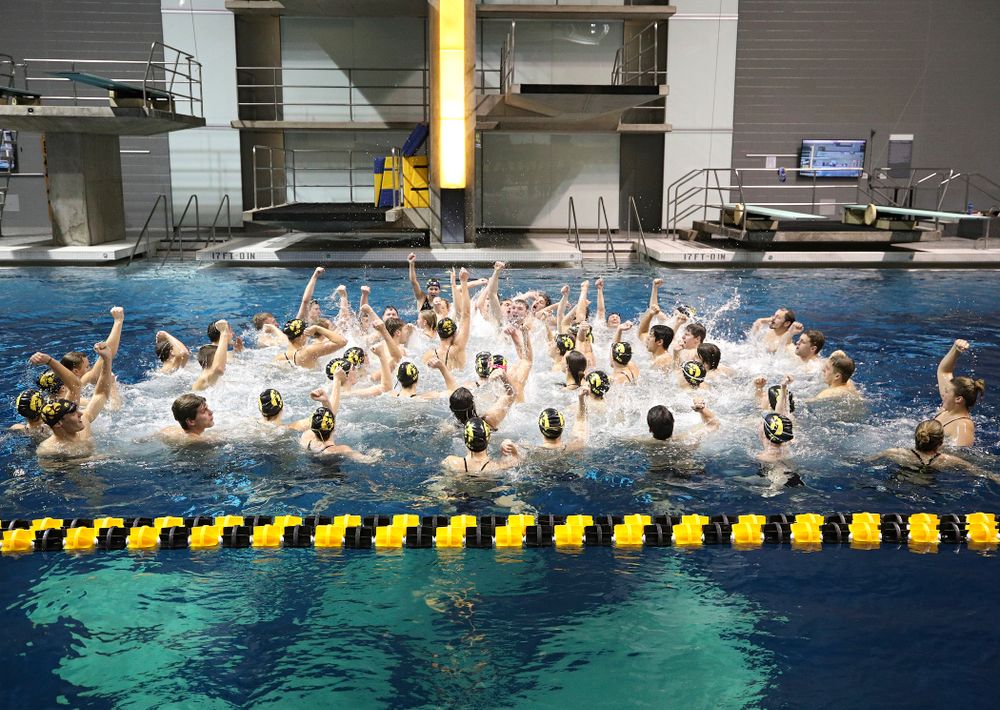 The Hawkeyes sing the Fight Song in the pool after their meet at the Campus Recreation and Wellness Center in Iowa City on Friday, February 7, 2020. (Stephen Mally/hawkeyesports.com)