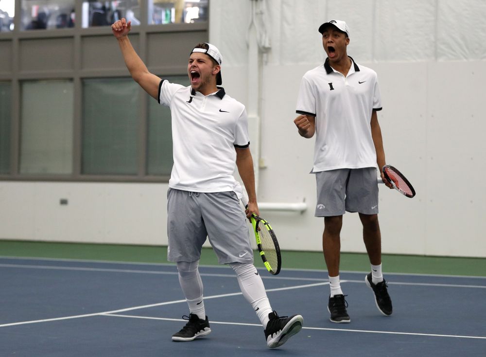 Iowa's Will Davies and Oliver Okonkwo celebrate after winning a doubles match against Western Michigan Saturday, January 19, 2019 at the Hawkeye Tennis and Recreation Complex. (Brian Ray/hawkeyesports.com)