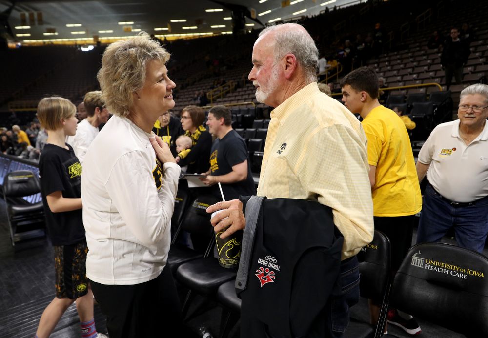 Iowa Hawkeyes head coach Lisa Bluder and supporter Ted Pacha during a celebration of their Big Ten Women's Basketball Tournament championship Monday, March 18, 2019 at Carver-Hawkeye Arena. (Brian Ray/hawkeyesports.com)
