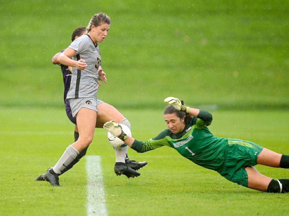 Iowa forward Gianna Gourley (32) tries to sneak a shot by Northwestern goalkeeper Mackenzie Wood (1) during overtime of their match at the Iowa Soccer Complex in Iowa City on Sunday, Sep 29, 2019. (Stephen Mally/hawkeyesports.com)