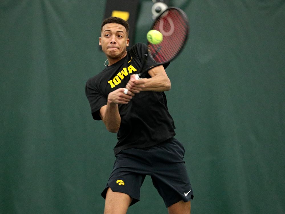 Iowa’s Oliver Okonkwo returns a shot during his singles match at the Hawkeye Tennis and Recreation Complex in Iowa City on Friday, February 14, 2020. (Stephen Mally/hawkeyesports.com)