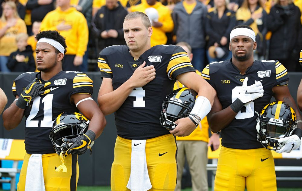Iowa Hawkeyes running back Ivory Kelly-Martin (21), quarterback Nate Stanley (4), and wide receiver Ihmir Smith-Marsette (6) stand for the National Anthem before their game at Kinnick Stadium in Iowa City on Saturday, Sep 28, 2019. (Stephen Mally/hawkeyesports.com)