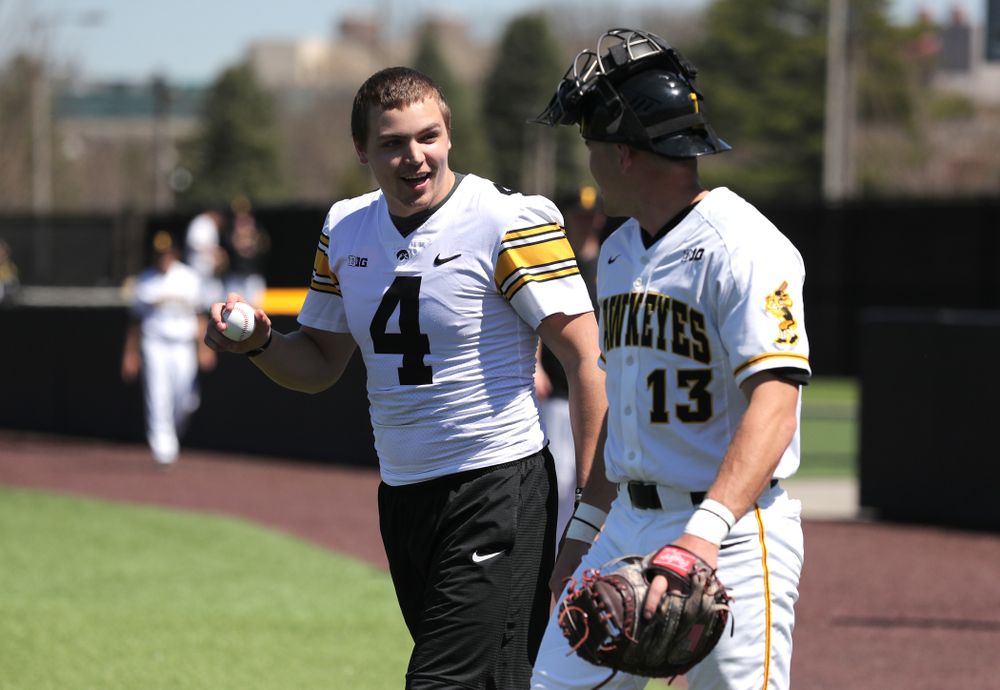 Iowa Hawkeyes quarterback Nate Stanley (4) throws out a first pitch against the Nebraska Cornhuskers Saturday, April 20, 2019 at Duane Banks Field. (Brian Ray/hawkeyesports.com)