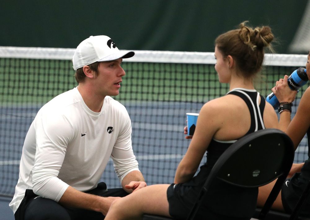 Assistant coach Daniel Leitner talks with Michelle Bacalla and Cloe Ruettte as they play a doubles match against the Penn State Nittany Lions Sunday, February 24, 2019 at the Hawkeye Tennis and Recreation Complex. (Brian Ray/hawkeyesports.com)