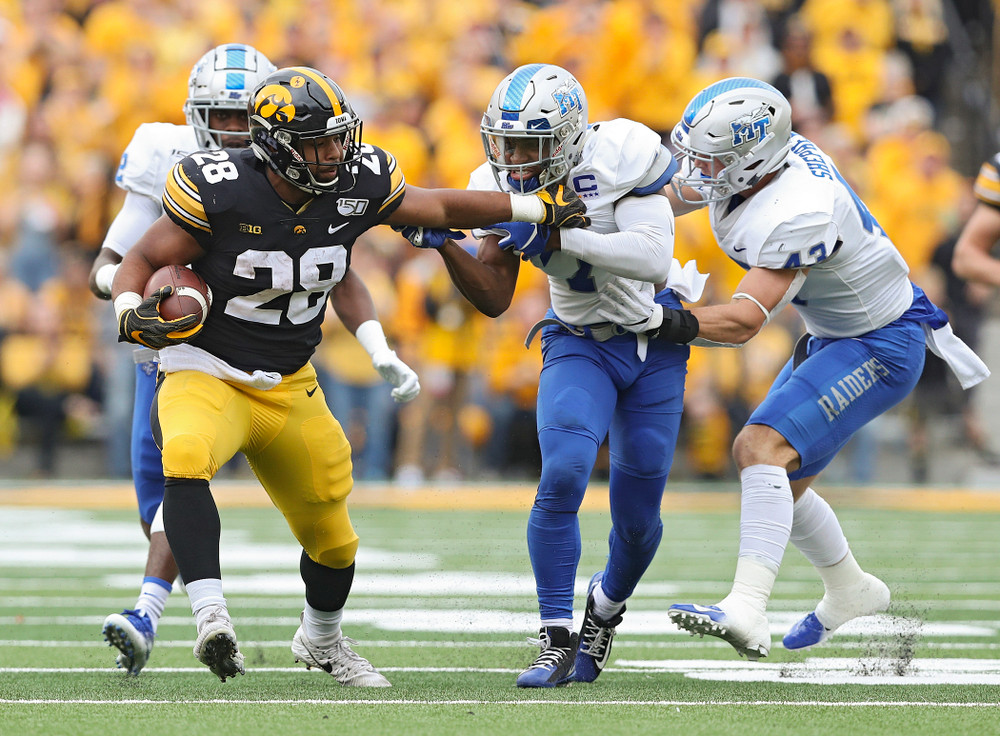 Iowa Hawkeyes running back Toren Young (28) drags defenders on a run during third quarter of their game at Kinnick Stadium in Iowa City on Saturday, Sep 28, 2019. (Stephen Mally/hawkeyesports.com)