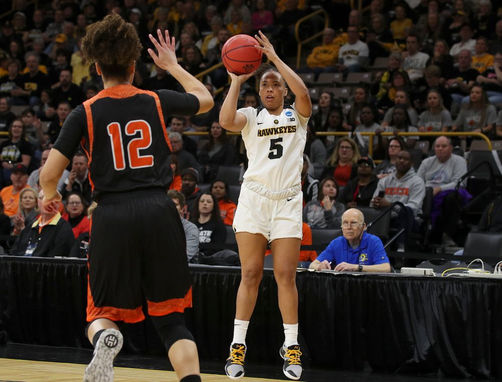 Iowa Hawkeyes guard Alexis Sevillian (5) shoots over Mercer Bears guard Tia Benvenuti (12) during the first round of the 2019 NCAA Women's Basketball Tournament at Carver Hawkeye Arena in Iowa City on Friday, Mar. 22, 2019. (Stephen Mally for hawkeyesports.com)
