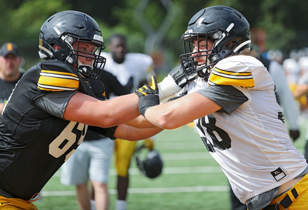 Iowa Hawkeyes offensive lineman Tyler Endres (69) and defensive lineman Chris Reames (98) run a drill during Fall Camp Practice No. 10 at the Hansen Football Performance Center in Iowa City on Tuesday, Aug 13, 2019. (Stephen Mally/hawkeyesports.com)