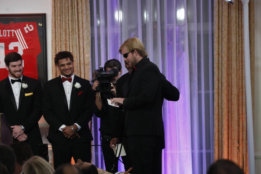 USC long-snapper Jake Olson, who is blind, announces the winners' name that was on a special envelope in braille. 