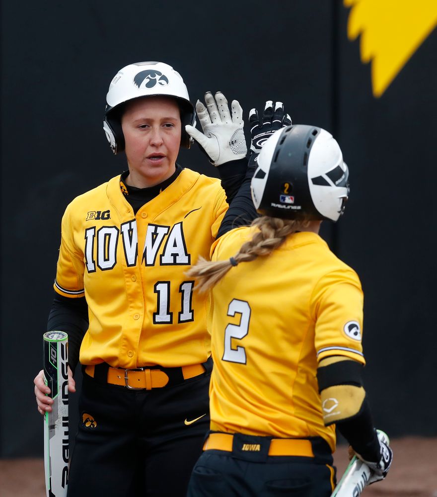 Iowa Hawkeyes starting pitcher/relief pitcher Mallory Kilian (11) and infielder Aralee Bogar (2) against UW Green Bay Tuesday, March 27, 2018 at Bob Pearl Field. (Brian Ray/hawkeyesports.com)