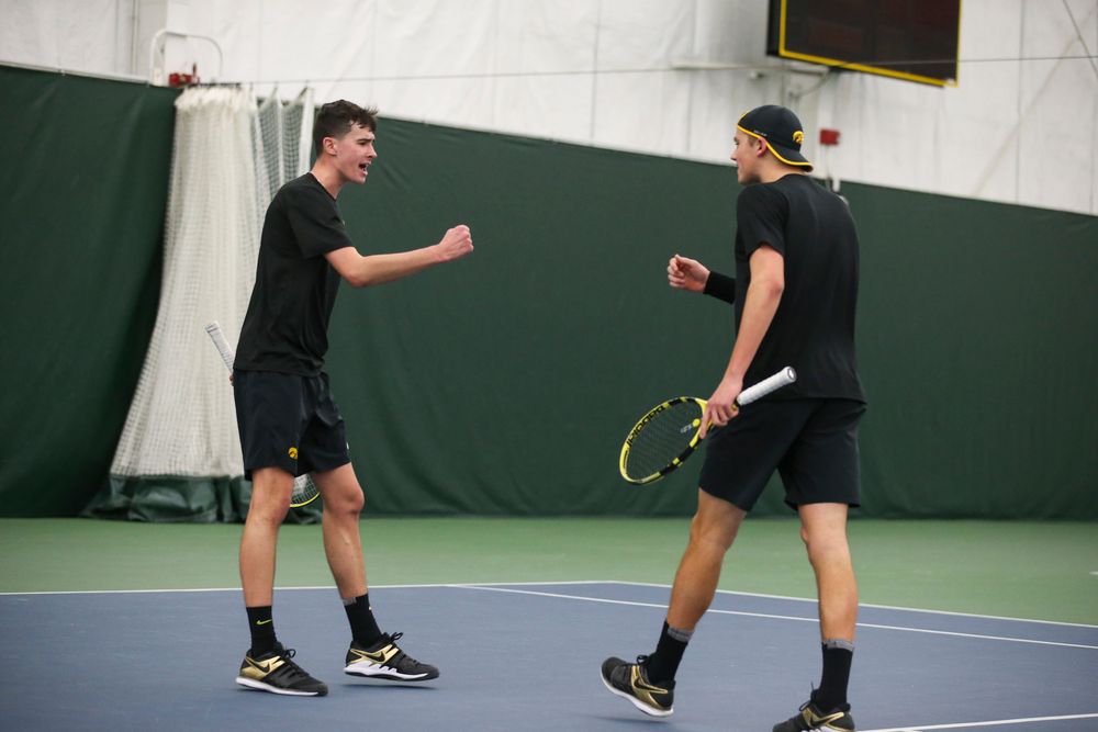 Iowa’s Matt Clegg and Joe Tyler celebrate a point during the Iowa men’s tennis meet vs VCU  on Saturday, February 29, 2020 at the Hawkeye Tennis and Recreation Complex. (Lily Smith/hawkeyesports.com)