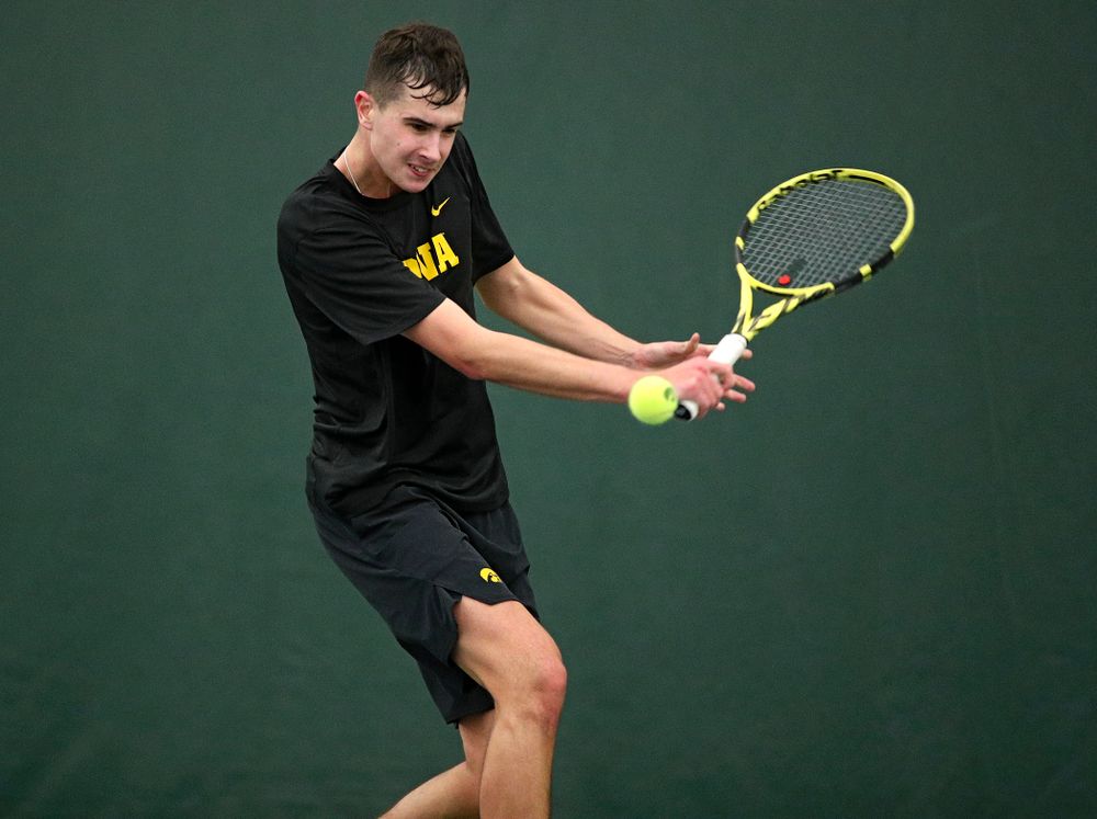 Iowa’s Matt Clegg hits a shot during his match against Marquette at the Hawkeye Tennis and Recreation Complex in Iowa City on Saturday, January 25, 2020. (Stephen Mally/hawkeyesports.com)