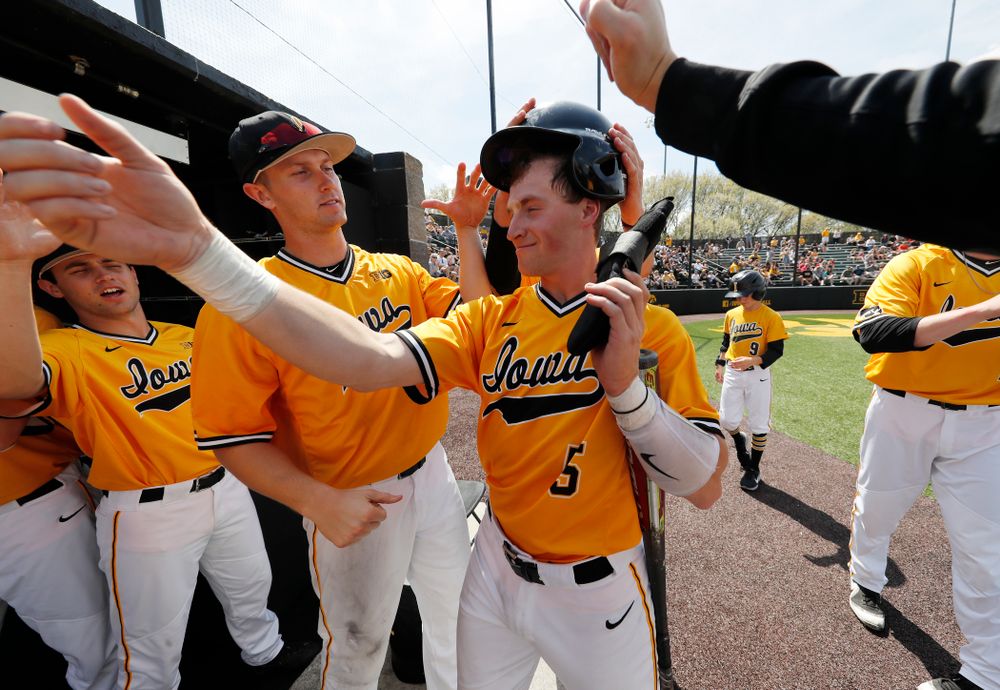 Iowa Hawkeyes catcher Tyler Cropley (5) high fives teammates after scoring against the Oklahoma State Cowboys Sunday, May 6, 2018 at Duane Banks Field. (Brian Ray/hawkeyesports.com)