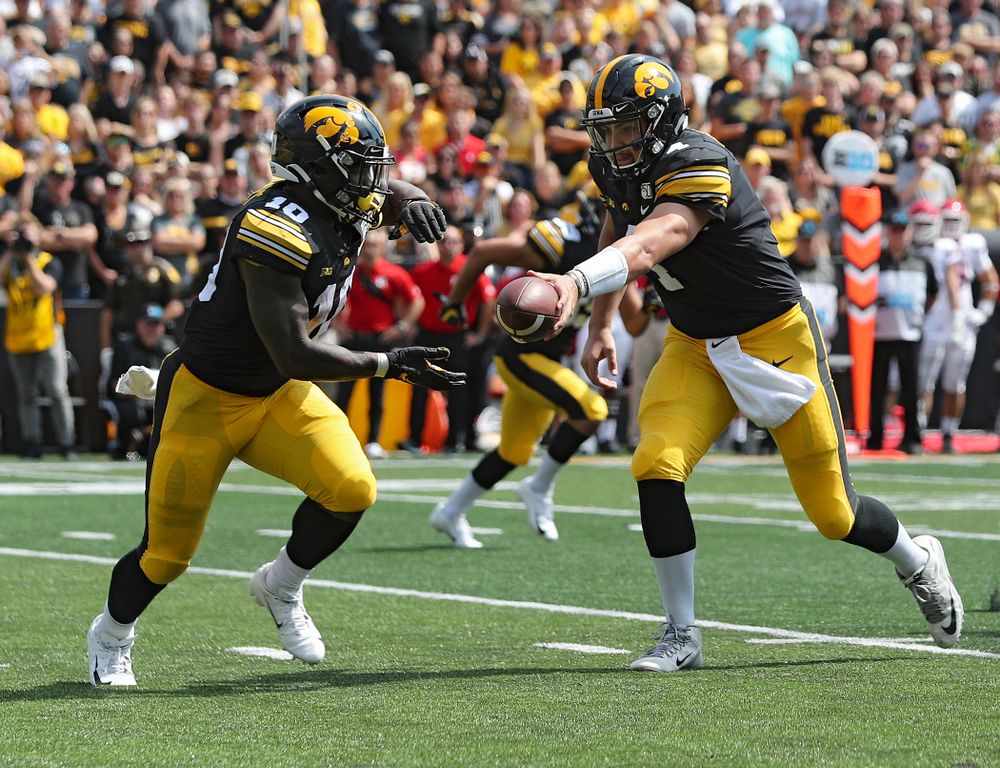 Iowa Hawkeyes quarterback Nate Stanley (4) hands off the ball to running back Mekhi Sargent (10) during the third quarter of their Big Ten Conference football game at Kinnick Stadium in Iowa City on Saturday, Sep 7, 2019. (Stephen Mally/hawkeyesports.com)