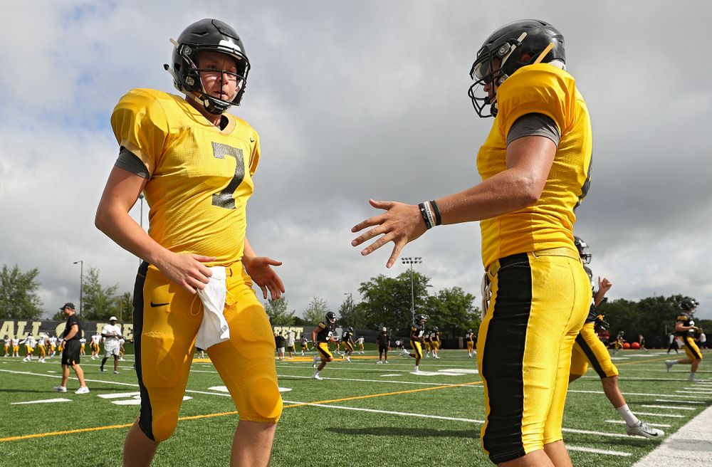 Iowa Hawkeyes quarterback Spencer Petras (7) is greeted by quarterback Nate Stanley (4) as they warm up during Fall Camp Practice No. 10 at the Hansen Football Performance Center in Iowa City on Tuesday, Aug 13, 2019. (Stephen Mally/hawkeyesports.com)