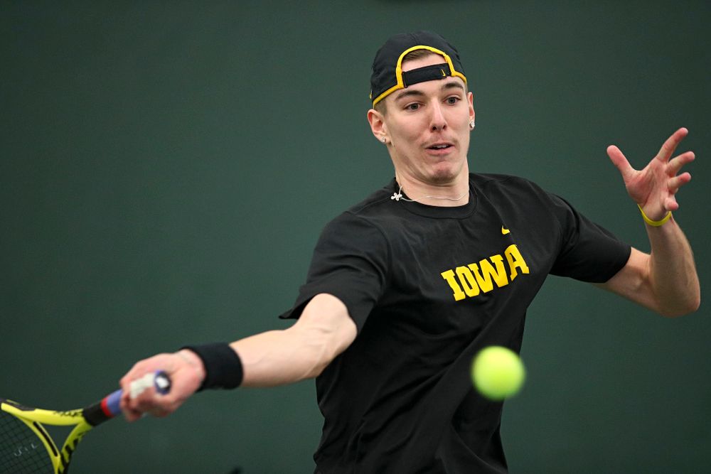 Iowa’s Nikita Snezhko lines up a shot during his doubles match at the Hawkeye Tennis and Recreation Complex in Iowa City on Friday, February 14, 2020. (Stephen Mally/hawkeyesports.com)