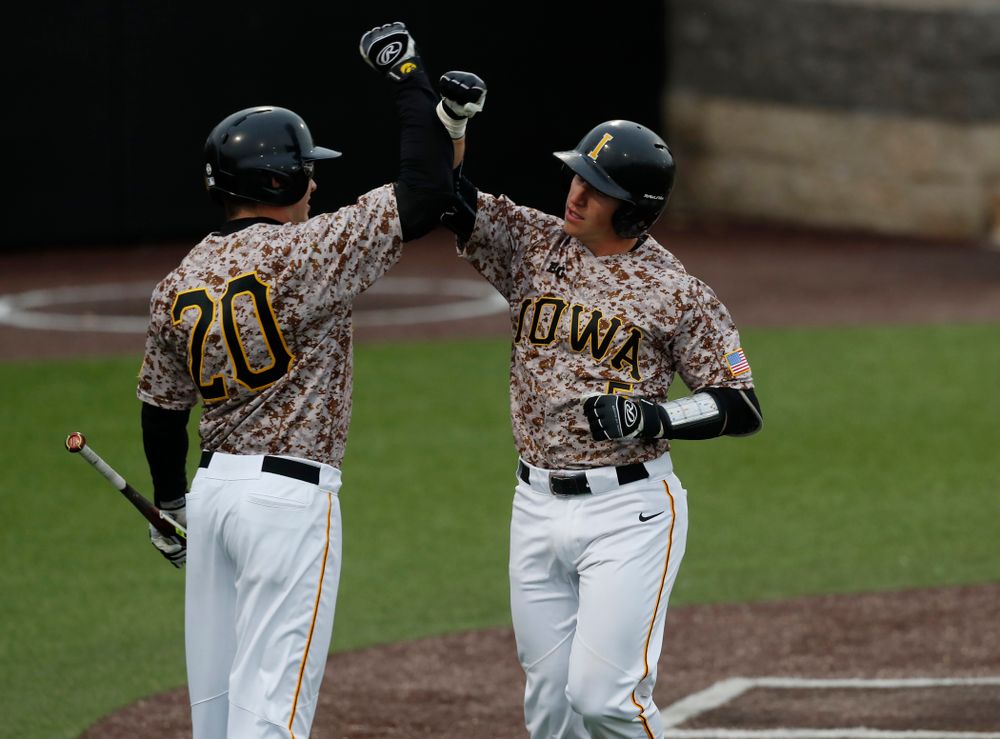 Iowa Hawkeyes catcher Tyler Cropley (5) and catcher Austin Guzzo (20) during a double header against the Indiana Hoosiers Friday, March 23, 2018 at Duane Banks Field. (Brian Ray/hawkeyesports.com)