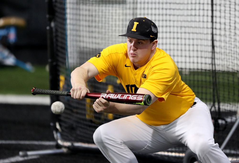 Iowa Hawkeyes first baseman Peyton Williams (45) puts down a bunt during practice Thursday, February 6, 2020 at the Indoor Practice Facility. (Brian Ray/hawkeyesports.com)