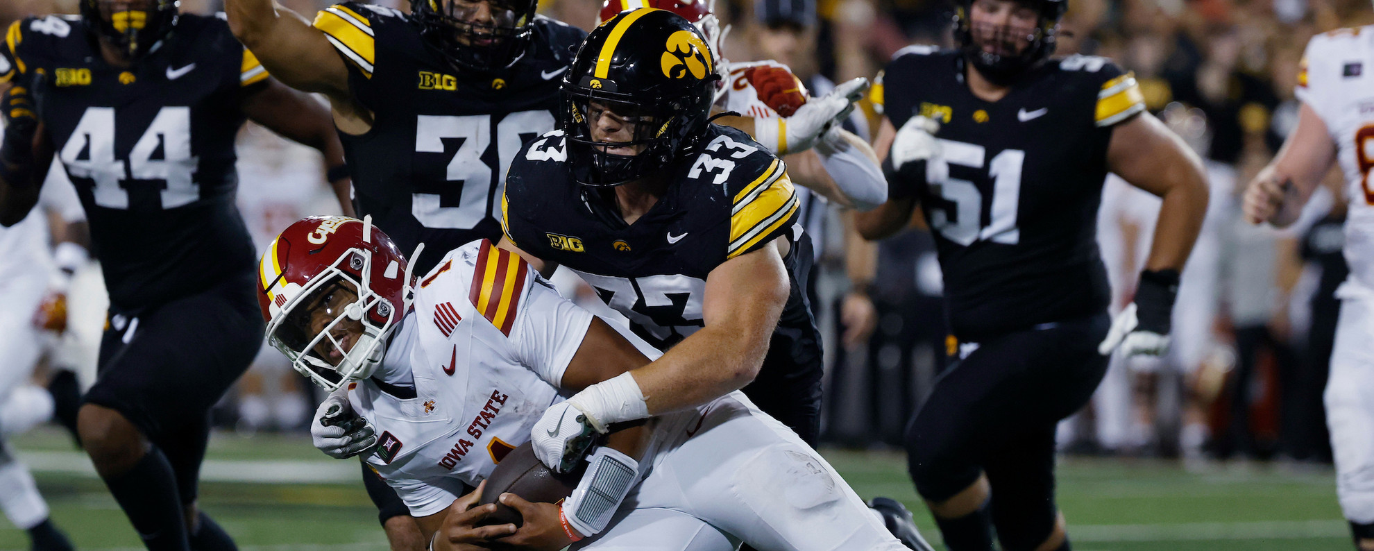 Cam Buffington tackles an Iowa State player.