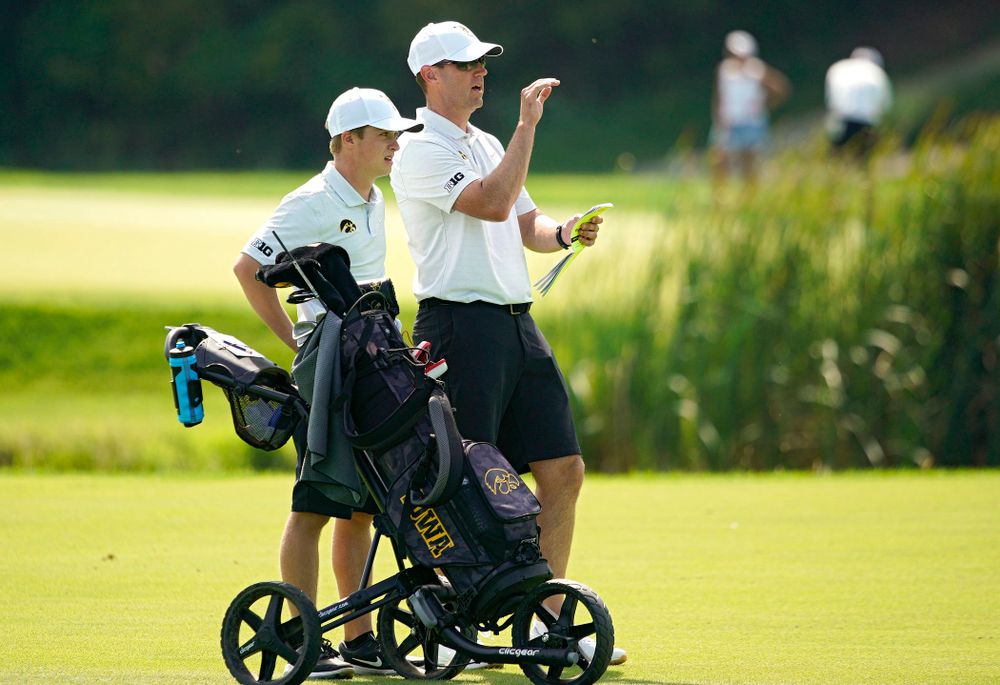 Iowa’s Matthew Garside (from left) talks with head coach Tyler Stith on the fairway during the second day of the Golfweek Conference Challenge at the Cedar Rapids Country Club in Cedar Rapids on Monday, Sep 16, 2019. (Stephen Mally/hawkeyesports.com)