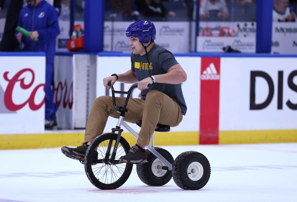 Iowa Hawkeyes quarterback Nate Stanley (4) rides a tricycle on the ice during a contest against Mississippi State in the first intermission of the Tampa Bay Lightning game Thursday, December 27, 2018 at Amalie Arena. (Brian Ray/hawkeyesports.com)