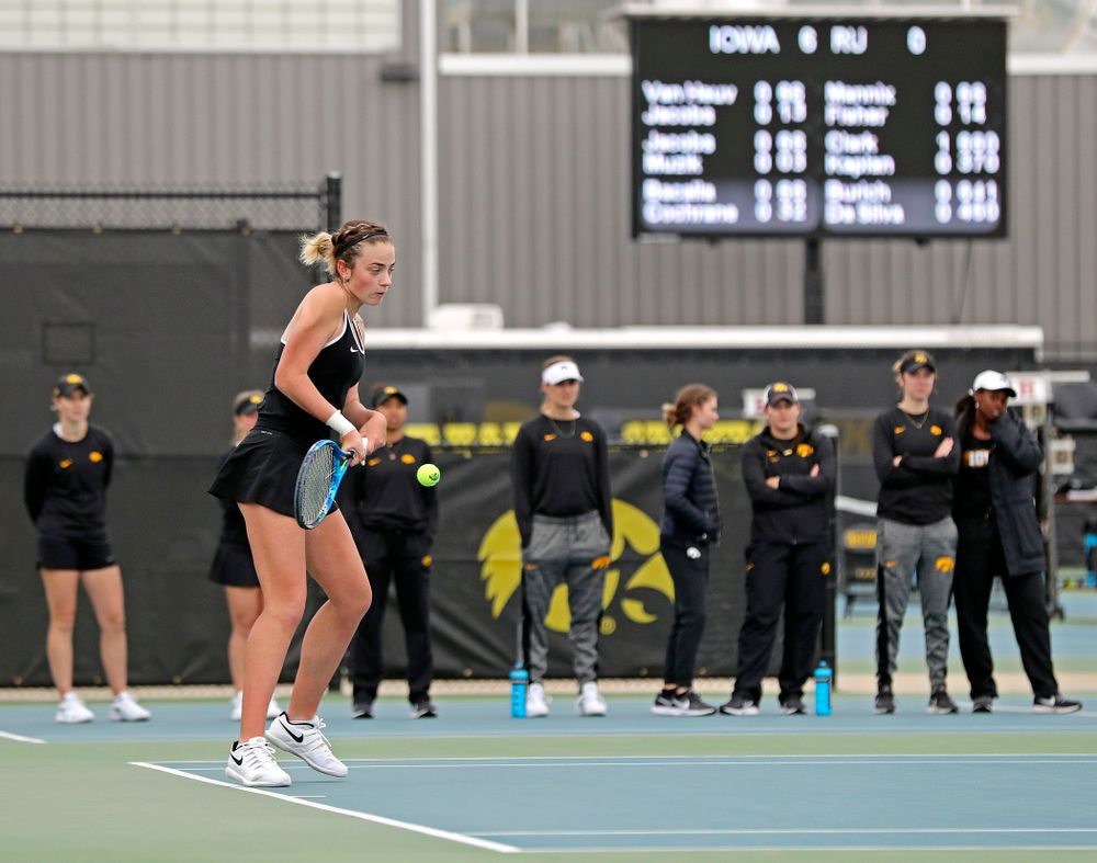 Iowa's Sophie Clark returns a shot as her teammates look on during a match against Rutgers at the Hawkeye Tennis and Recreation Complex in Iowa City on Friday, Apr. 5, 2019. (Stephen Mally/hawkeyesports.com)