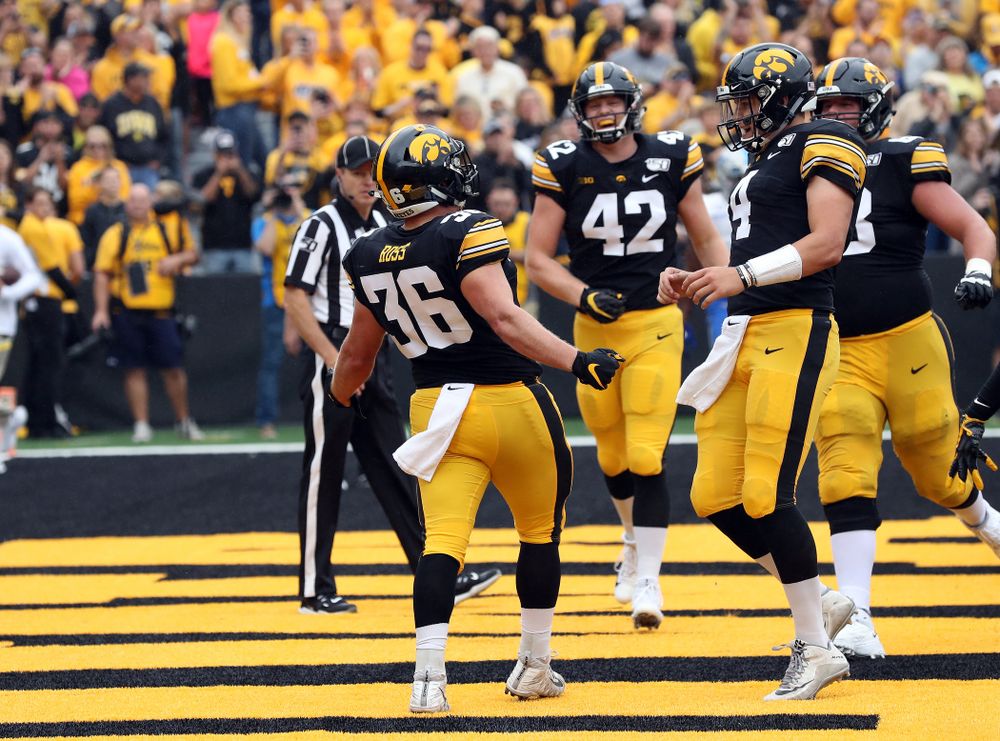 Iowa Hawkeyes fullback Brady Ross (36) celebrates with Iowa Hawkeyes quarterback Nate Stanley (4) after scoring a touchdown against Middle Tennessee State Saturday, September 28, 2019 at Kinnick Stadium. (Brian Ray/hawkeyesports.com)