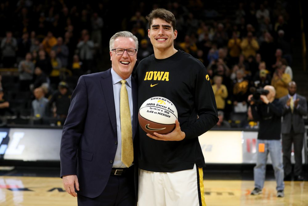 Iowa Hawkeyes forward Luka Garza (55) receives a ball commemorating his 1000th point from head coach Fran McCaffery before their game against the Minnesota Golden Gophers Monday, December 9, 2019 at Carver-Hawkeye Arena. (Brian Ray/hawkeyesports.com)