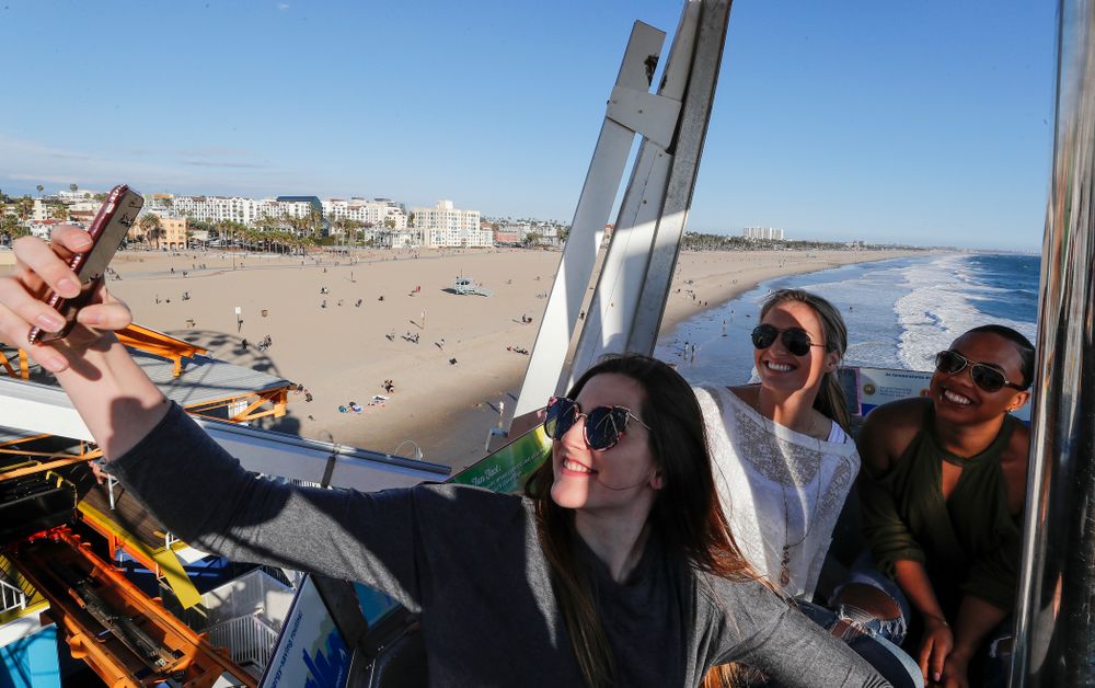 Iowa Hawkeyes forward Megan Gustafson (10) takes a selfie with guard Makenzie Meyer (3), guard Alexis Sevillian (5) and guard Tania Davis (11) as they ride the ferris wheel in Pacific Park on the Santa Monica Pier Thursday, March 15, 2018 in Santa Monica. (Brian Ray/hawkeyesports.com)