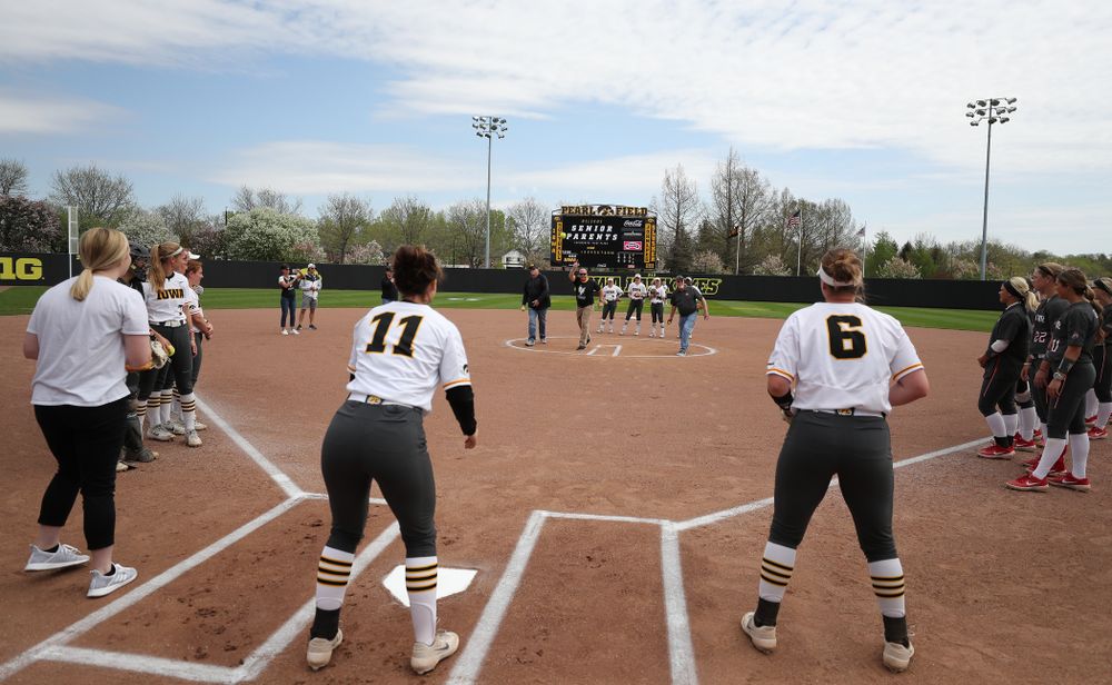 The fathers of seniors Brooke Rozier, Mallory Kilian (11), and Erin Riding throw out a first pitch against the Ohio State Buckeyes on senior day Sunday, May 5, 2019 at Pearl Field. (Brian Ray/hawkeyesports.com)
