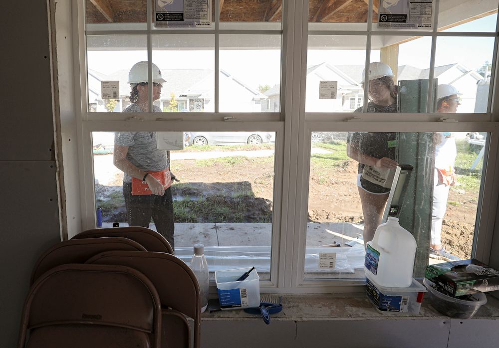 Iowa assistant coach Abby Stamp (from left) and McKenna Warnock work on a Habitat for Humanity Women Build project in Iowa City on Wednesday, Sep 25, 2019. (Stephen Mally/hawkeyesports.com)