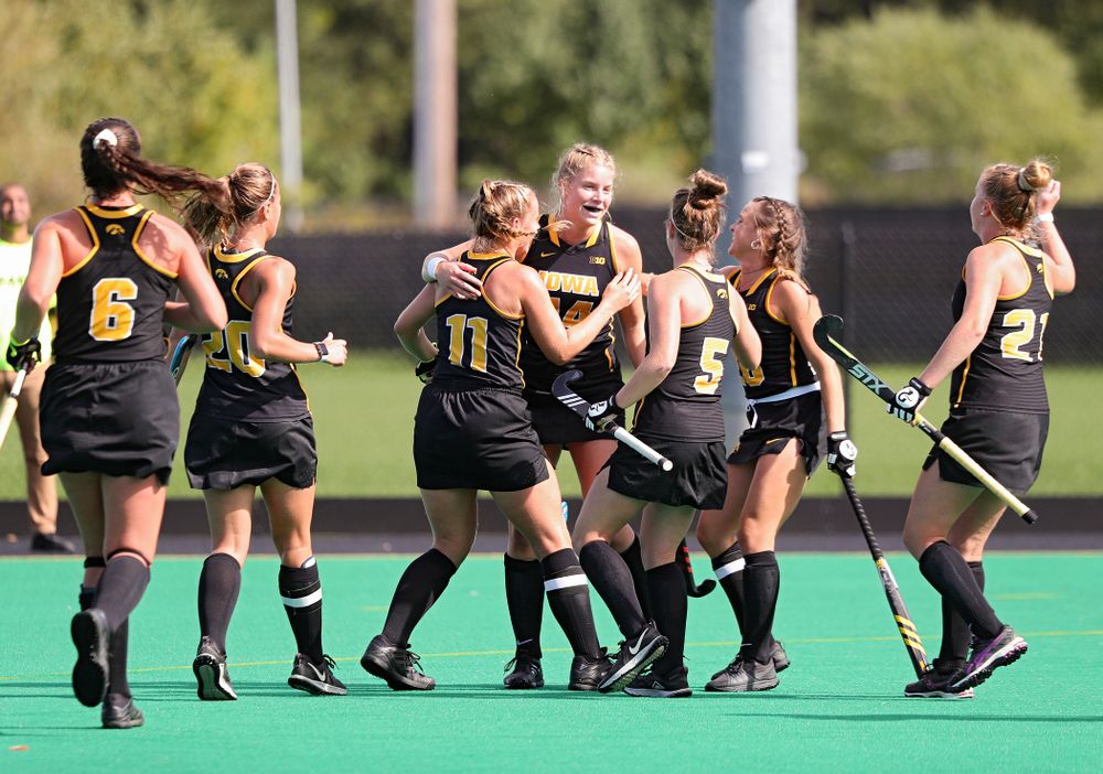 Iowa’s Lokke Stribos (14) celebrates with teammates after scoring a goal during the first quarter of their match at Grant Field in Iowa City on Friday, Oct 4, 2019. (Stephen Mally/hawkeyesports.com)