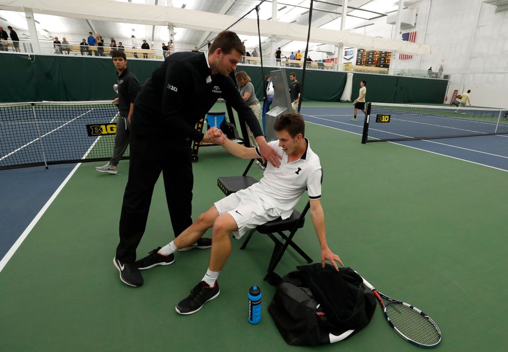 Iowa's Piotr Smietana celebrates with his teammates after clinching the match against Purdue Sunday, April 15, 2018 at the Hawkeye Tennis an
