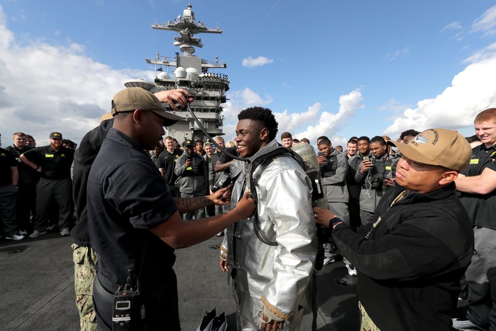 Iowa Hawkeyes running back Keontae Luckett (20) puts on a firefighting suit during a tour of the USS Theodore Roosevelt (CVN-71) Tuesday, December 24, 2019 at the Naval Base Coronado. (Brian Ray/hawkeyesports.com)