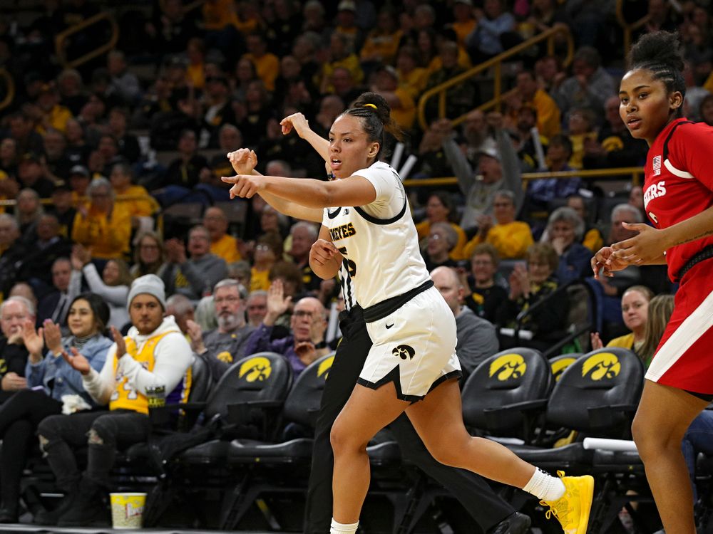 Iowa Hawkeyes guard Alexis Sevillian (5) points after making a 3-pointer during the second quarter of the game at Carver-Hawkeye Arena in Iowa City on Thursday, February 6, 2020. (Stephen Mally/hawkeyesports.com)
