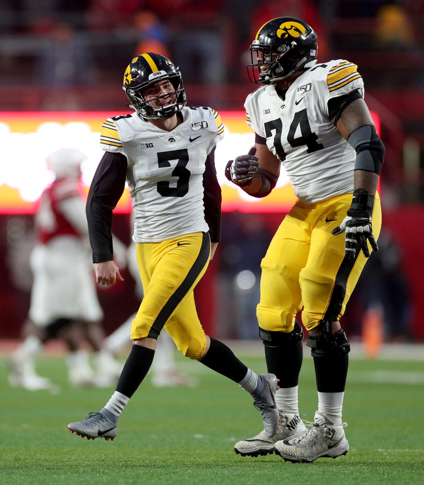 Iowa Hawkeyes place kicker Keith Duncan (3) celebrates with offensive lineman Tristan Wirfs (74) after kicking the game winning field goal against the Nebraska Cornhuskers Friday, November 29, 2019 at Memorial Stadium in Lincoln, Neb. (Brian Ray/hawkeyesports.com)