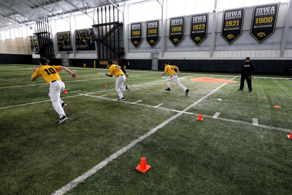 Iowa Hawkeyes assistant coach Marty Sutherland runs a base running drill during practice Thursday, February 6, 2020 at the Indoor Practice Facility. (Brian Ray/hawkeyesports.com)