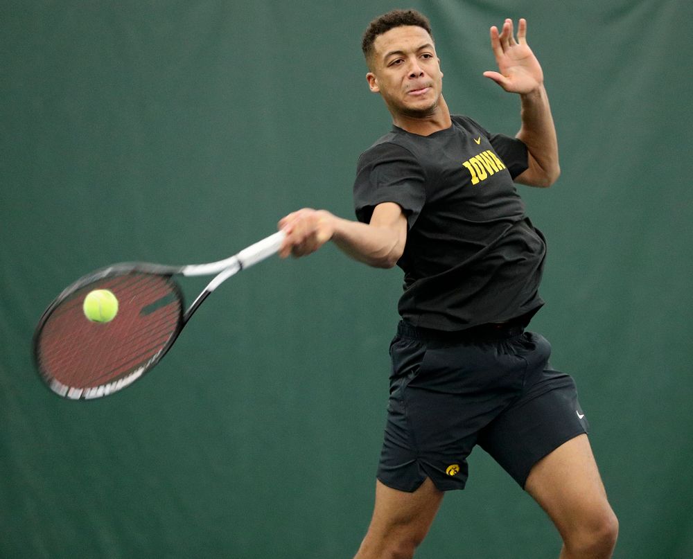 Iowa’s Oliver Okonkwo returns a shot during their match at the Hawkeye Tennis and Recreation Complex in Iowa City on Thursday, January 16, 2020. (Stephen Mally/hawkeyesports.com)