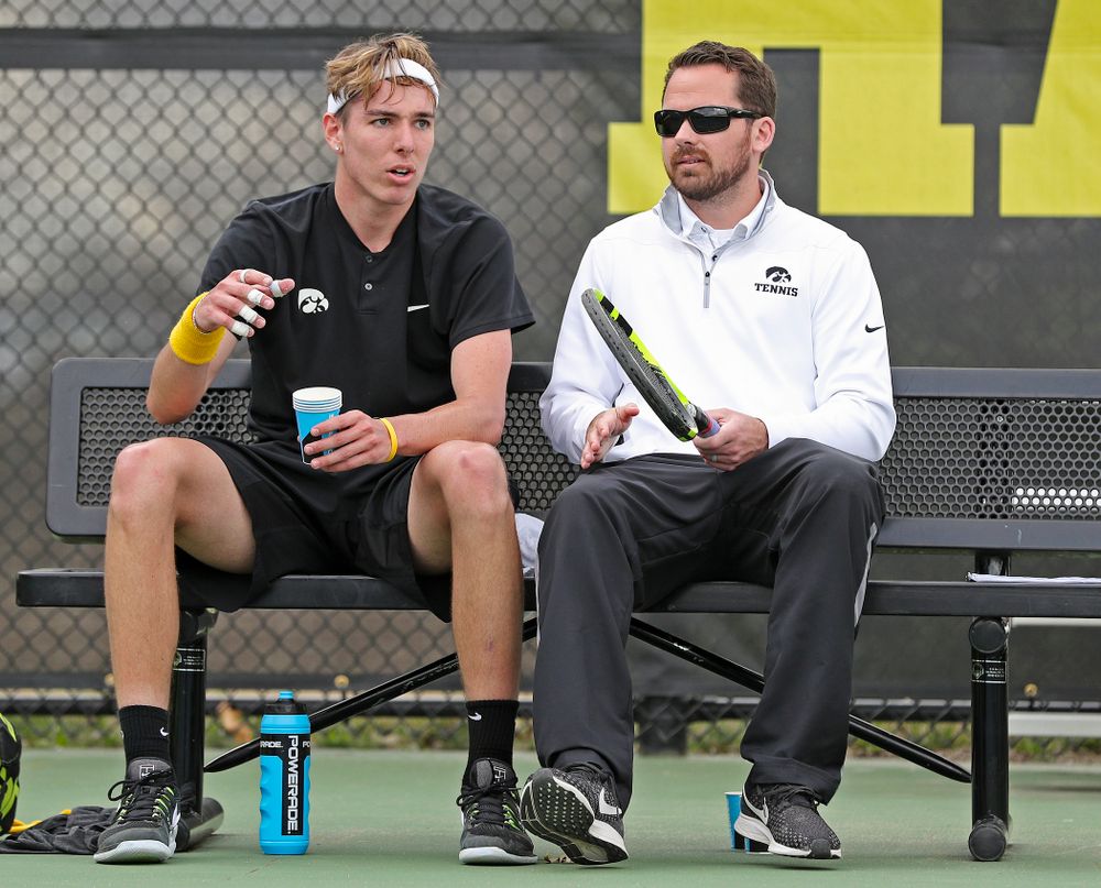 Iowa's Nikita Snezhko talks with head coach Ross Wilson during a match against Ohio State at the Hawkeye Tennis and Recreation Complex in Iowa City on Sunday, Apr. 7, 2019. (Stephen Mally/hawkeyesports.com)