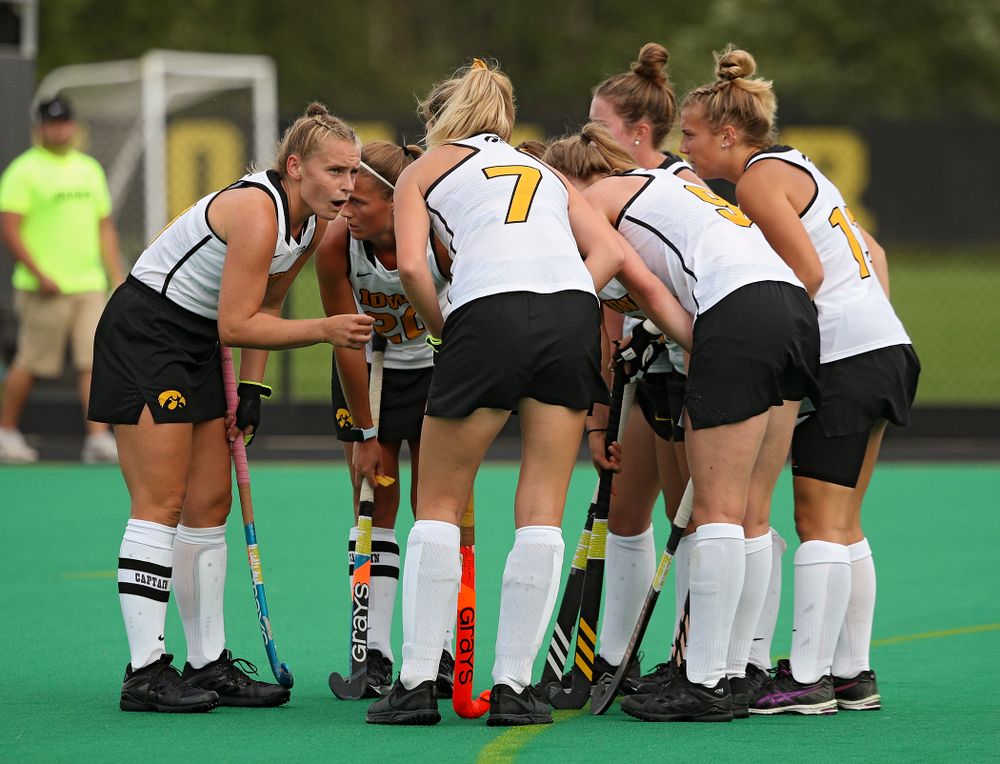 Iowa’s Katie Birch (11) talks with her teammates before a penalty corner during the first quarter of their game at Grant Field in Iowa City on Friday, Sep 13, 2019. (Stephen Mally/hawkeyesports.com)