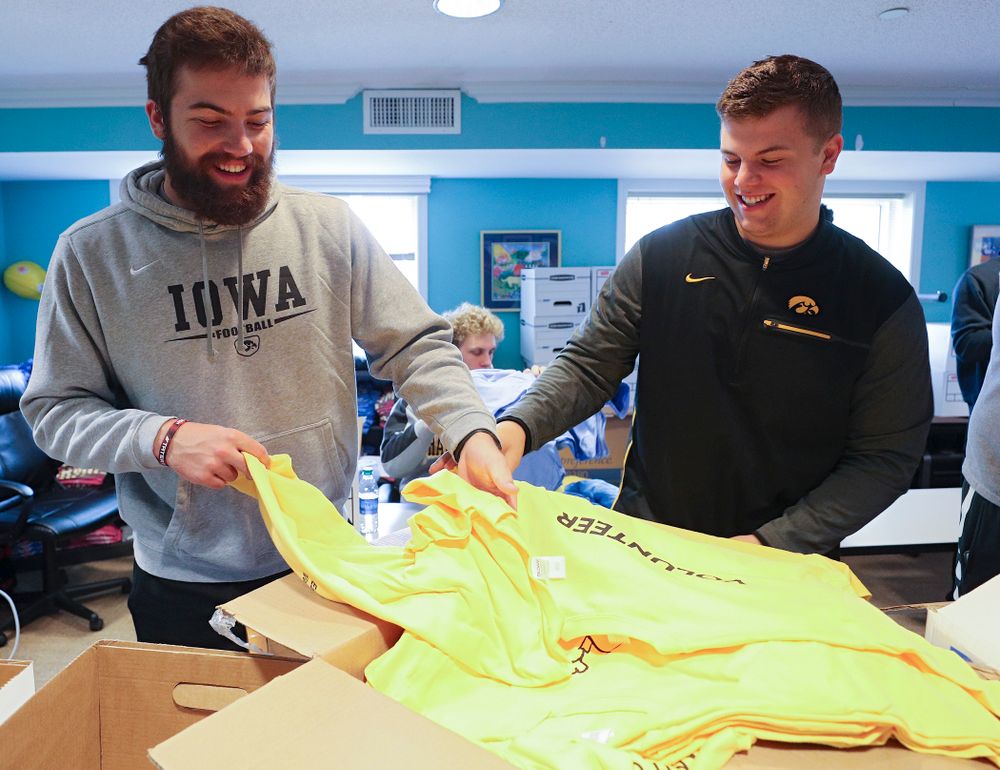 Iowa football players help fold shirts at the Ronald McDonald House for their Red Shoe Run/Walk during the 21st annual ISAAC Hawkeye Day of Caring in Iowa City on Sunday, Apr. 28, 2019. (Stephen Mally/hawkeyesports.com)