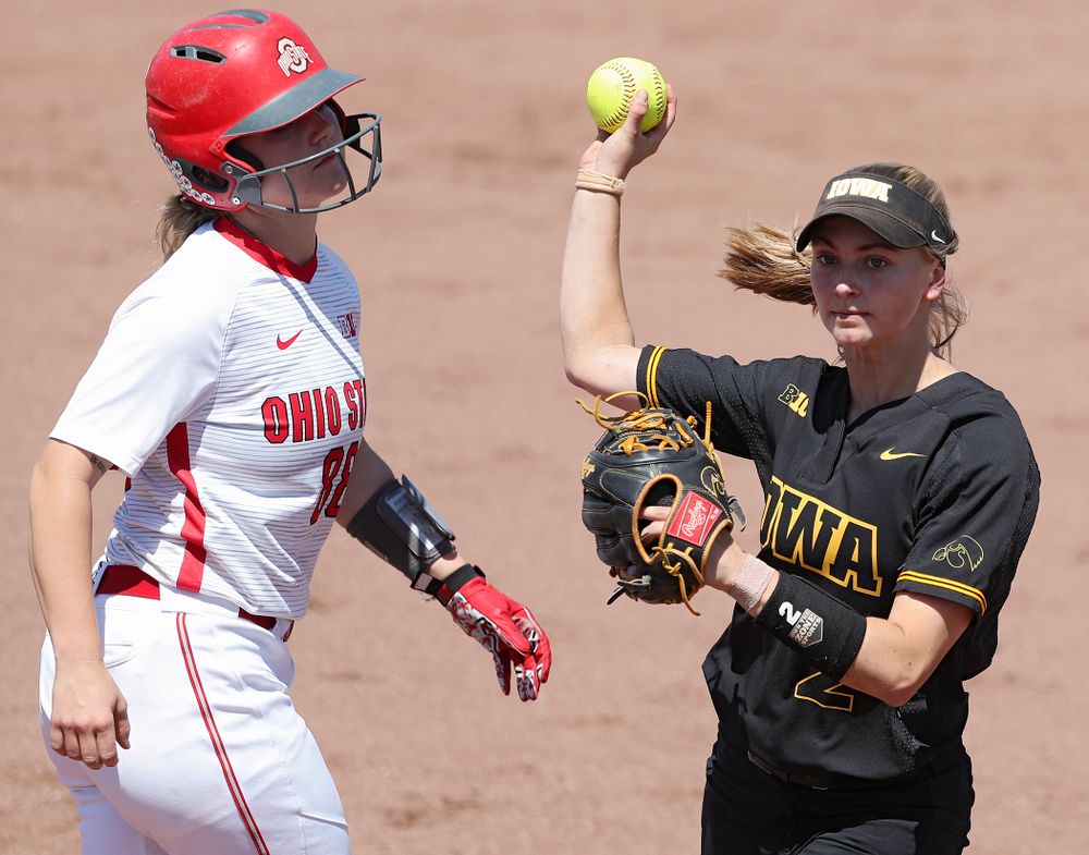 Iowa second baseman Aralee Bogar (2) throws to first base after tagging out a runner as she turns a double play during the second inning of their game against Ohio State at Pearl Field in Iowa City on Saturday, May. 4, 2019. (Stephen Mally/hawkeyesports.com)