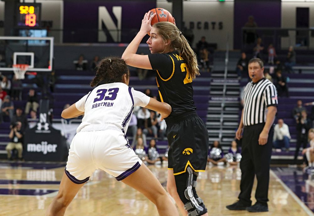 Iowa Hawkeyes guard Kate Martin (20) looks to pass during the fourth quarter of their game at Welsh-Ryan Arena in Evanston, Ill. on Sunday, January 5, 2020. (Stephen Mally/hawkeyesports.com)