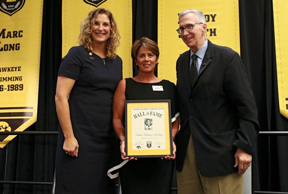 Barb Randall (from left), co-chair of the Varsity Club Advisory Committee, 2019 University of Iowa Athletics Hall of Fame inductee Deb Brickey, and Andy Piro, assistant athletics director and executive director of the Varsity Club, during the Hall of Fame Induction Ceremony at the Coralville Marriott Hotel and Conference Center in Coralville on Friday, Aug 30, 2019. (Stephen Mally/hawkeyesports.com)
