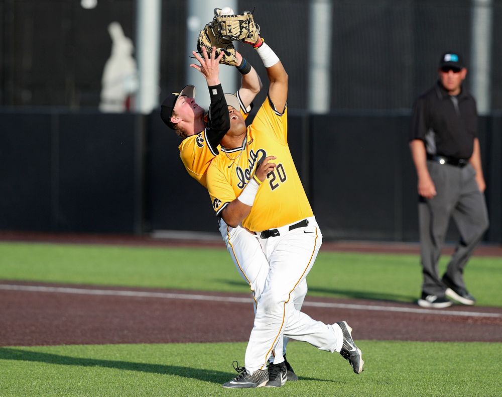 Iowa Hawkeyes second baseman Brendan Sher (2) makes contact with first baseman Izaya Fullard (20) as Fullard pulls in a pop up for an out during the sixth inning of their game against Northern Illinois at Duane Banks Field in Iowa City on Tuesday, Apr. 16, 2019. (Stephen Mally/hawkeyesports.com)