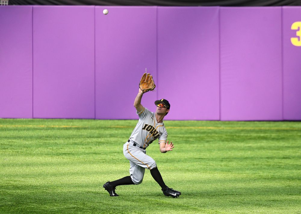 Iowa Hawkeyes outfielder Justin Jenkins (6) pulls in a fly ball for an out during the third inning of their CambriaCollegeClassic game at U.S. Bank Stadium in Minneapolis, Minn. on Friday, February 28, 2020. (Stephen Mally/hawkeyesports.com)