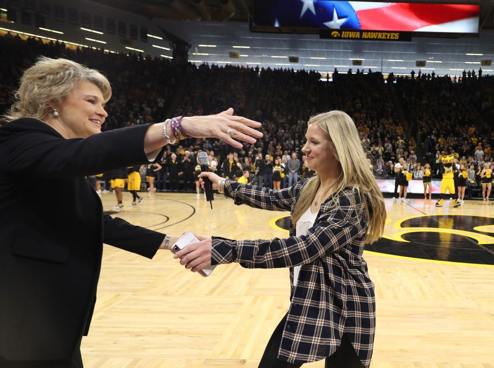 Iowa Hawkeyes head coach Lisa Bluder watches as her daughter Emma sings the National Anthem before the Iowa Hawkeyes game against the Northwestern Wildcats Sunday, March 3, 2019 at Carver-Hawkeye Arena. (Brian Ray/hawkeyesports.com)