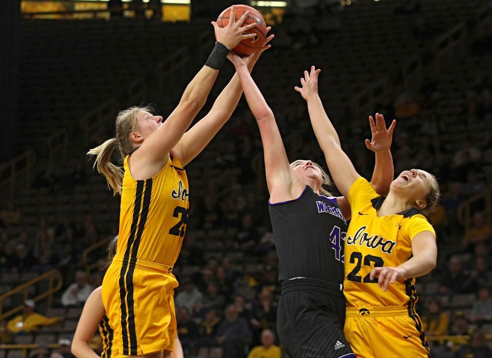 Iowa forward/center Monika Czinano (25) pulls in a rebound as guard Kathleen Doyle (22) tries to reach the ball during the second quarter of their game against Winona State at Carver-Hawkeye Arena in Iowa City on Sunday, Nov 3, 2019. (Stephen Mally/hawkeyesports.com)