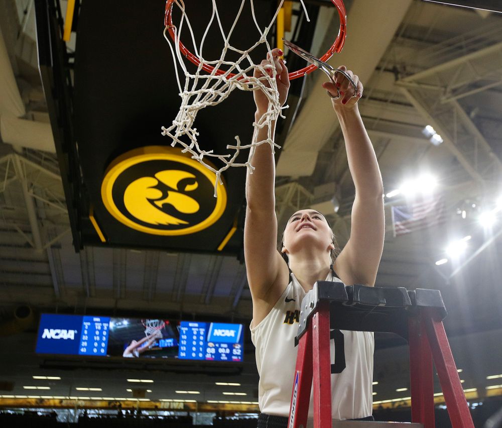 Iowa Hawkeyes center Megan Gustafson (10) cuts down the net after winning their second round game in the 2019 NCAA Women's Basketball Tournament at Carver Hawkeye Arena in Iowa City on Sunday, Mar. 24, 2019. (Stephen Mally for hawkeyesports.com)